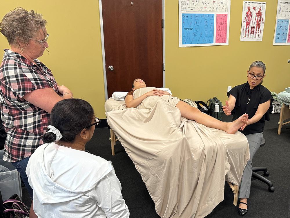 ANMT Program Instructor Gracia Rodriguez (right) demonstrates neuromuscular therapy techniques