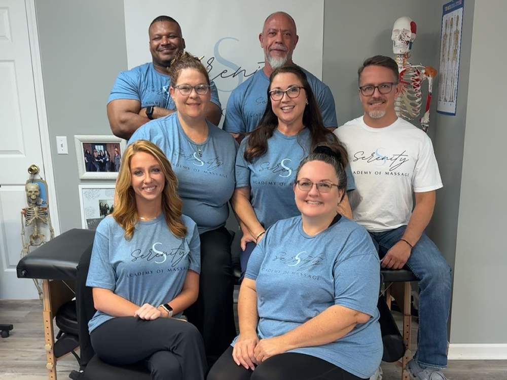 Tawnya Coia (middle left) with her first group of students. Denair (top left), Mike (top right), Breanna (bottom left) and Darlene (bottom right). Serenity Academy of Massage Owner, Stephanie (center) with her fiancé Keith (middle right).