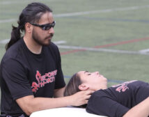 Paul Gowans working with an athlete on the sidelines