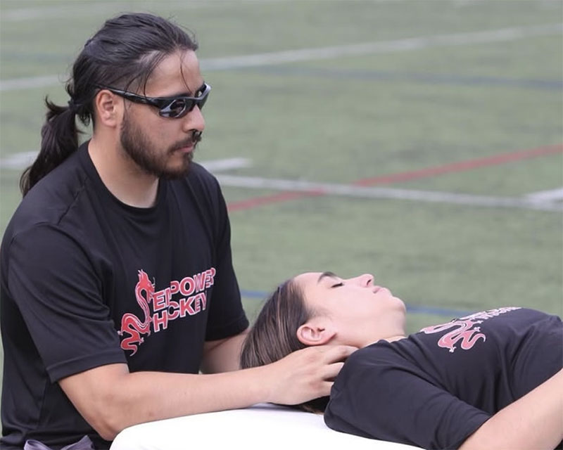 Paul Gowans working with an athlete on the sidelines